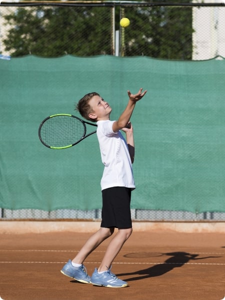 long-shot-kid-serving-tennis-field